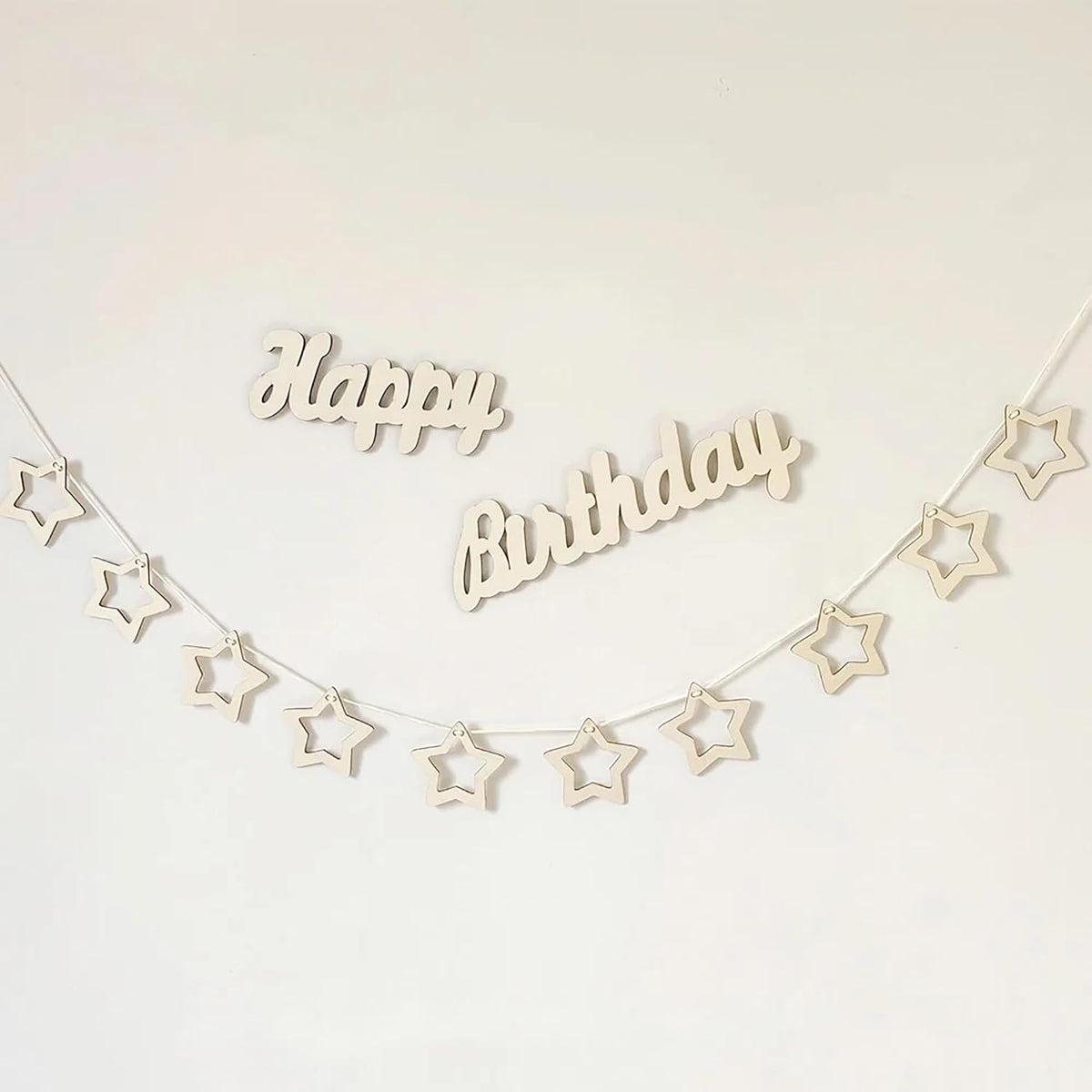 Wooden 'Happy Birthday' banner with star shapes on a white background