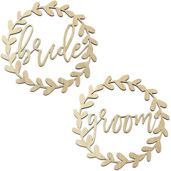 Wooden signs with 'bride' and 'groom' text surrounded by leaf patterns on a white background