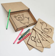 Cardboard cutouts of animals and letters with markers on a white background