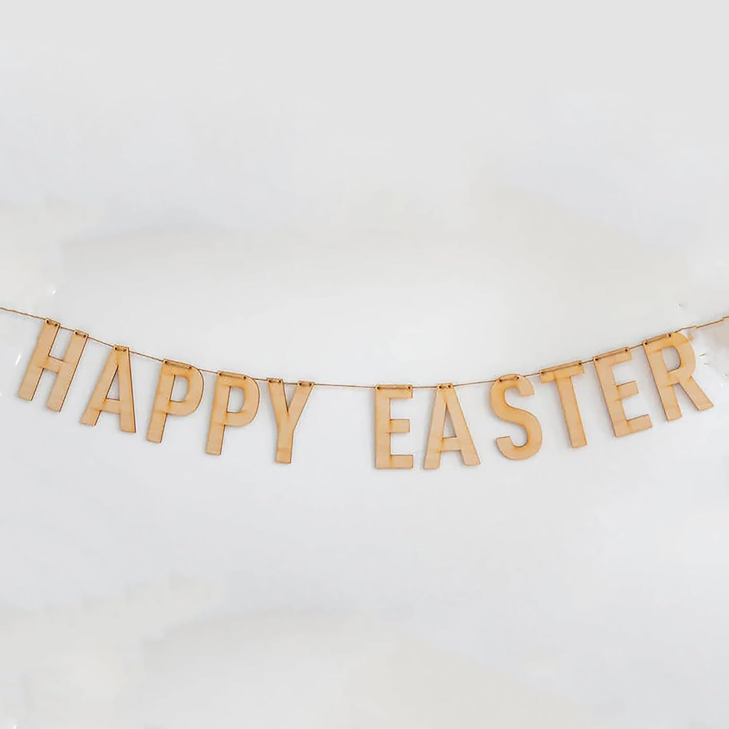 Wooden 'Happy Easter' banner on a white background