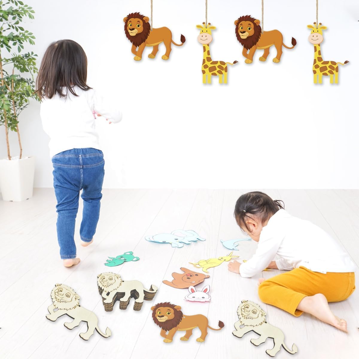 Children playing with wooden animal toys on a white floor.