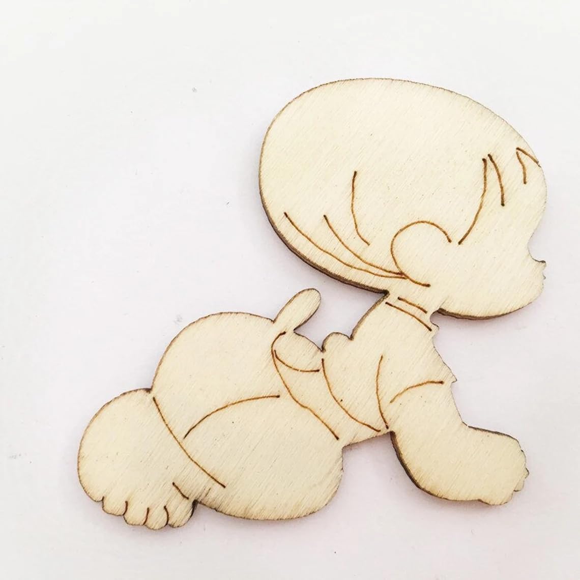 Wooden cutout of a cartoon character on a white background