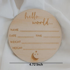 Wooden circular plaque with engraved text and moon design on a white fabric background