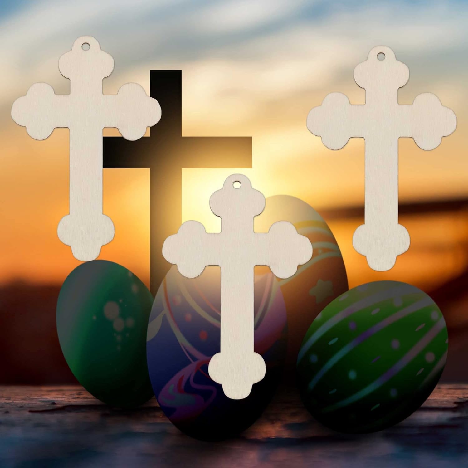 Decorative crosses and Easter eggs with a sunset background