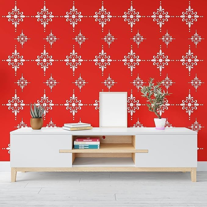 White entertainment console with wooden shelf against a red wall with white geometric pattern