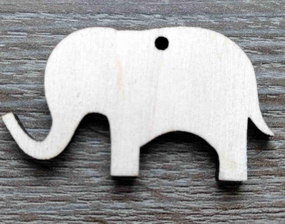 White elephant-shaped object on a wooden surface
