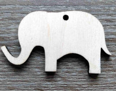 White elephant-shaped object on a wooden surface