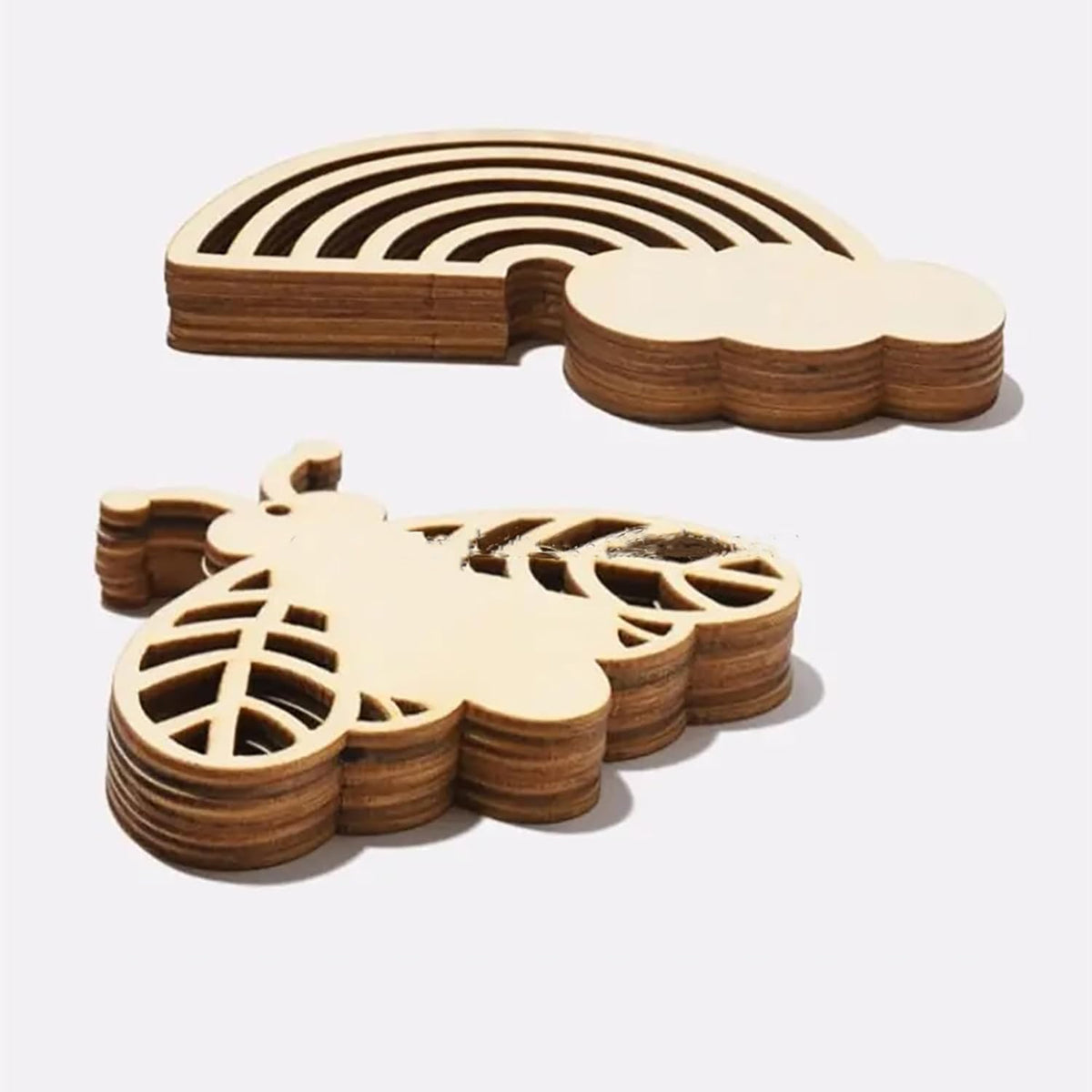 Wooden coasters shaped like a cloud and a leaf on a white background