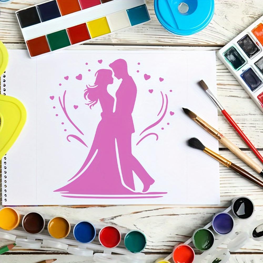 Painting of a couple in pink on a white paper with watercolor paints and brushes around.