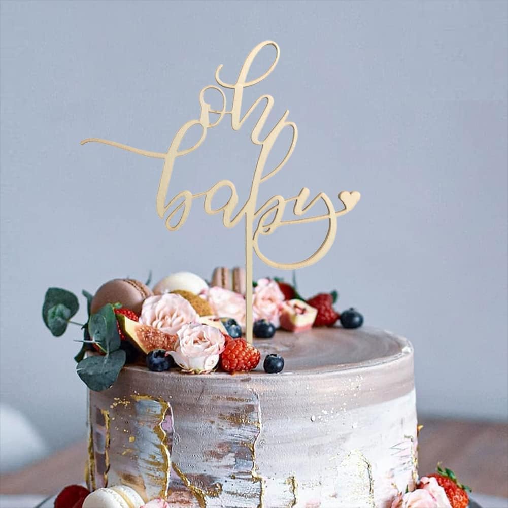 Decorative cake with 'oh my baby' topper on a light blue background