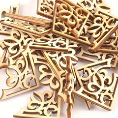 Wooden decorative pieces with intricate carvings on a white background