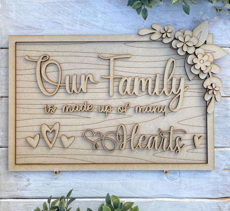 Wooden decorative sign with 'Our Family is made up of many Hearts' text on a light wooden background.