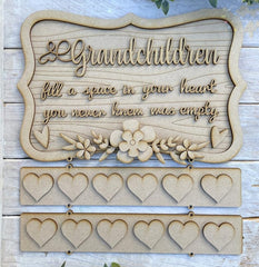 Wooden plaque with engraved text and heart shapes on a wooden background