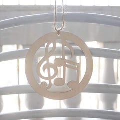 Decorative wooden ornament with musical notes on a white background