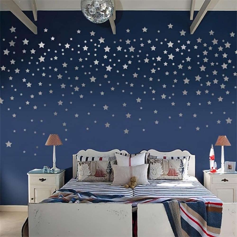 Bedroom with star-patterned wall, bed with striped bedding, and nightstands with lamps.