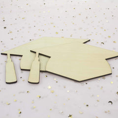 Graduation cap cutout on a decorative background with stars and confetti