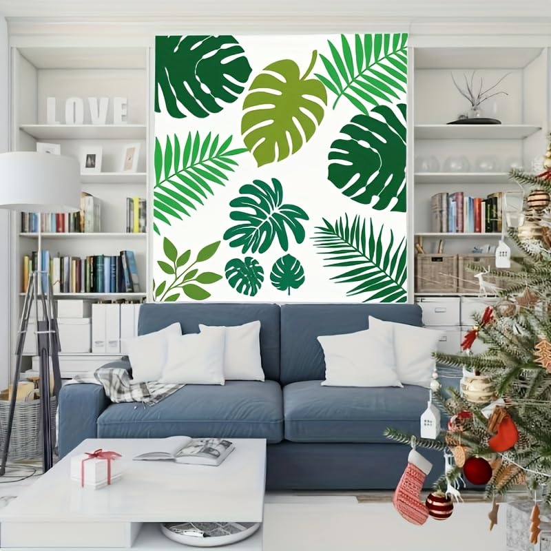 Living room with a blue sofa, Christmas tree, and decorative wall art with green leaves.