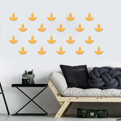 Wall with decorative yellow candle decals above a modern sofa and side table.