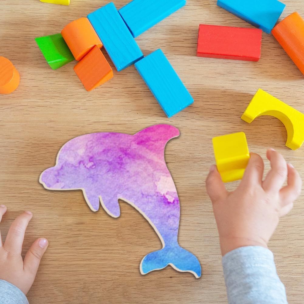 Child playing with colorful building blocks on a wooden surface, with a dolphin cutout nearby.