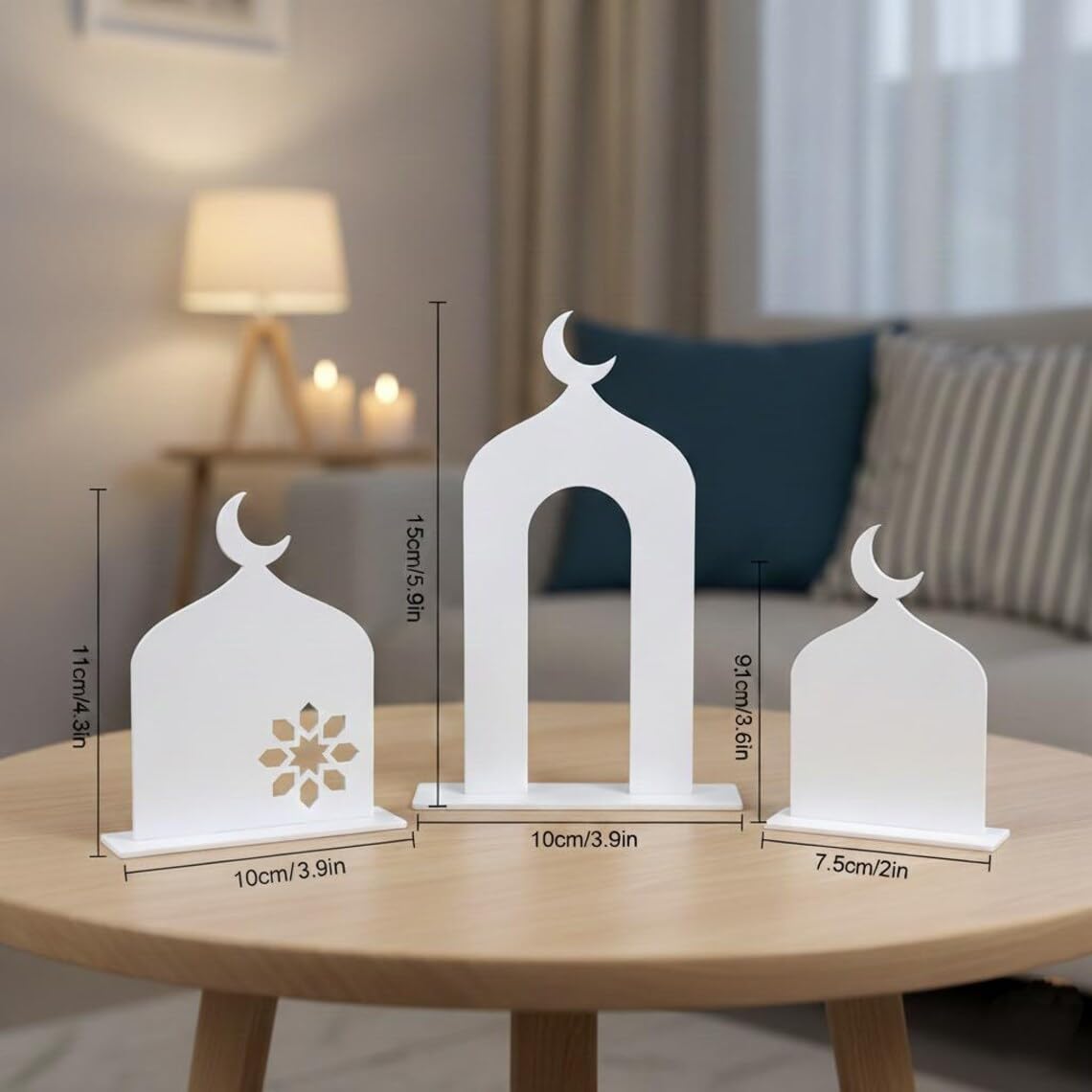 Three white decorative lanterns on a wooden table with measurements, living room background.