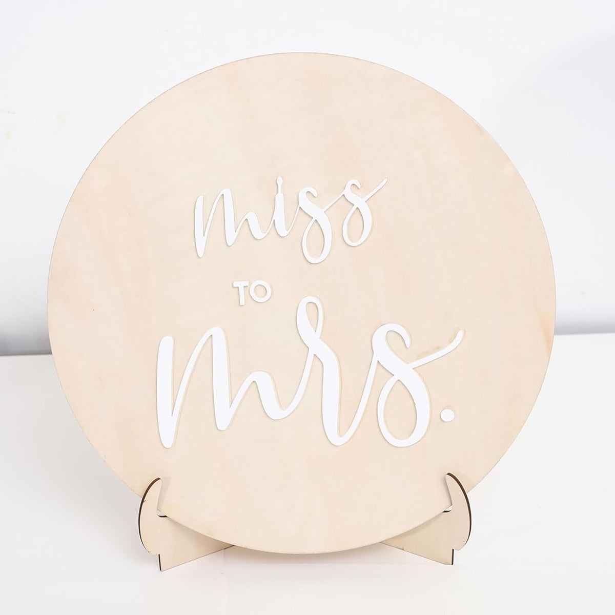 Round beige box with 'Miss to Mrs.' text on a white background