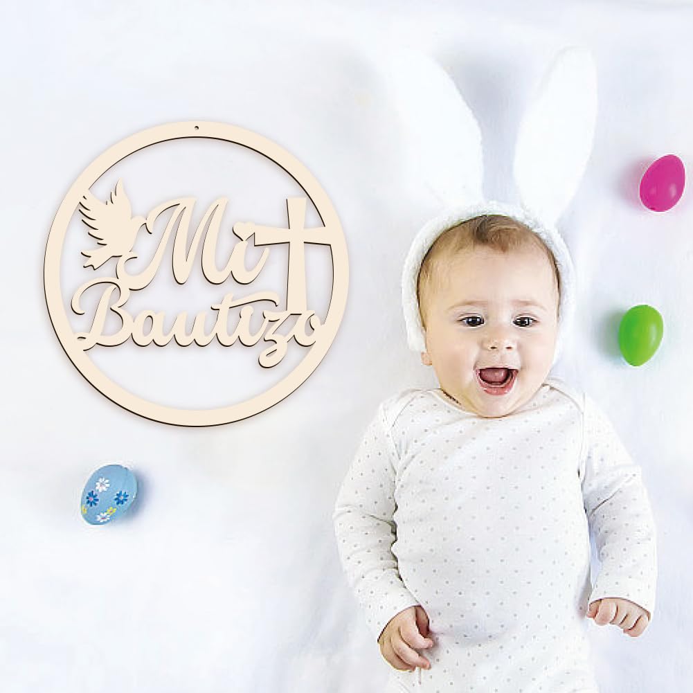 Baby in a white outfit with colorful eggs on a light background, next to a wooden decorative sign.