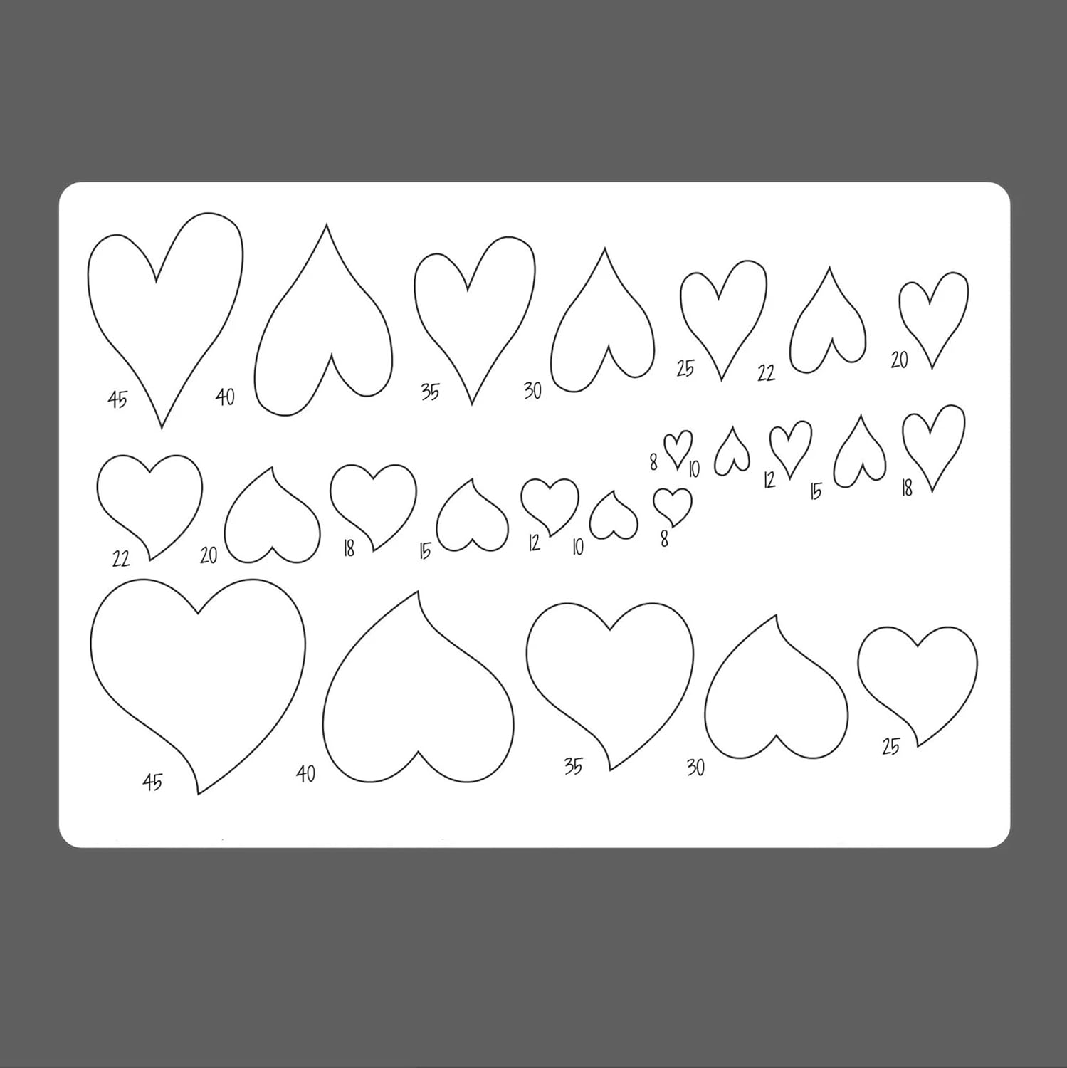 Sheet of heart-shaped templates with measurements on a gray background