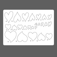 Sheet of heart-shaped templates with measurements on a gray background