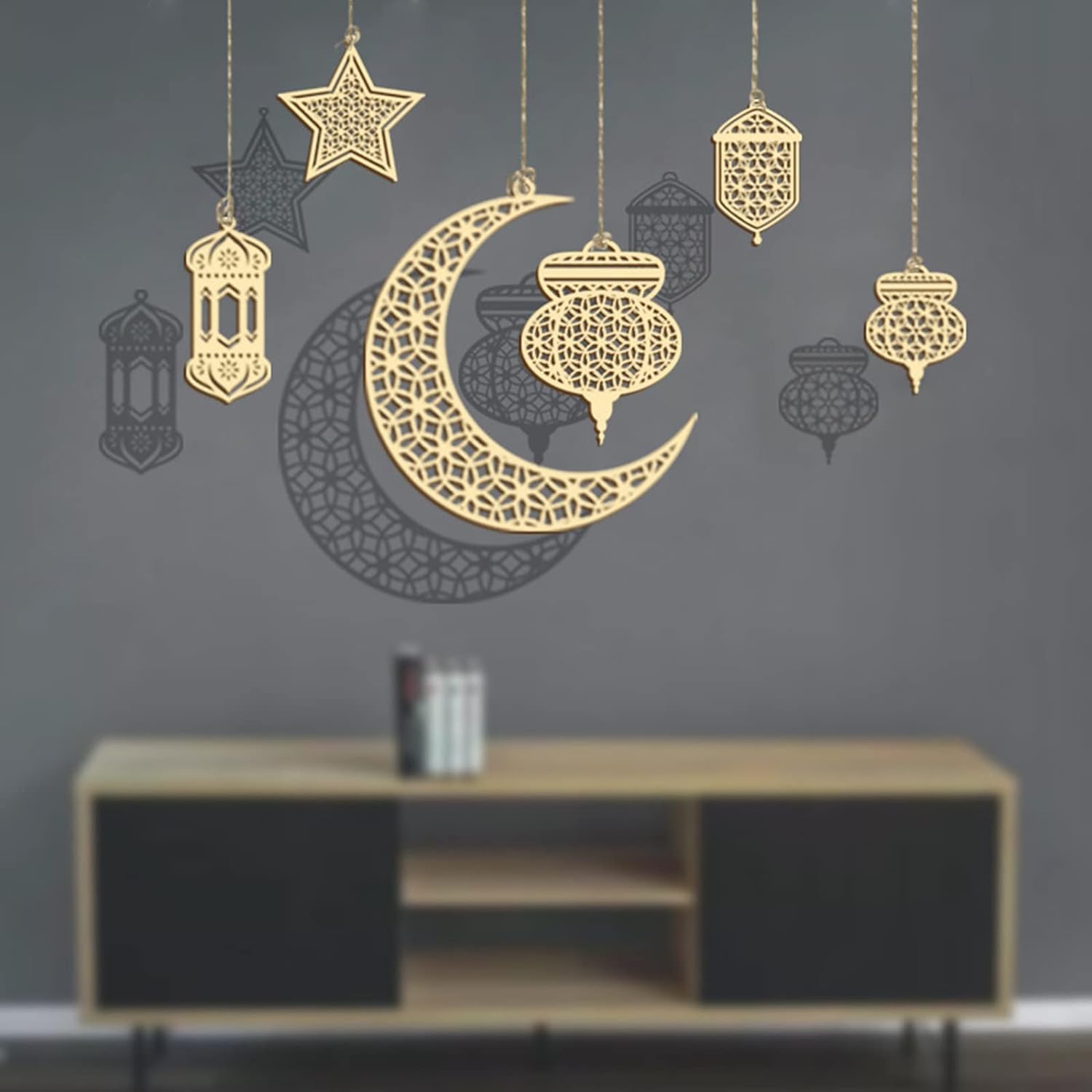 Decorative wall stickers of a crescent moon, star, and lanterns on a dark wall.