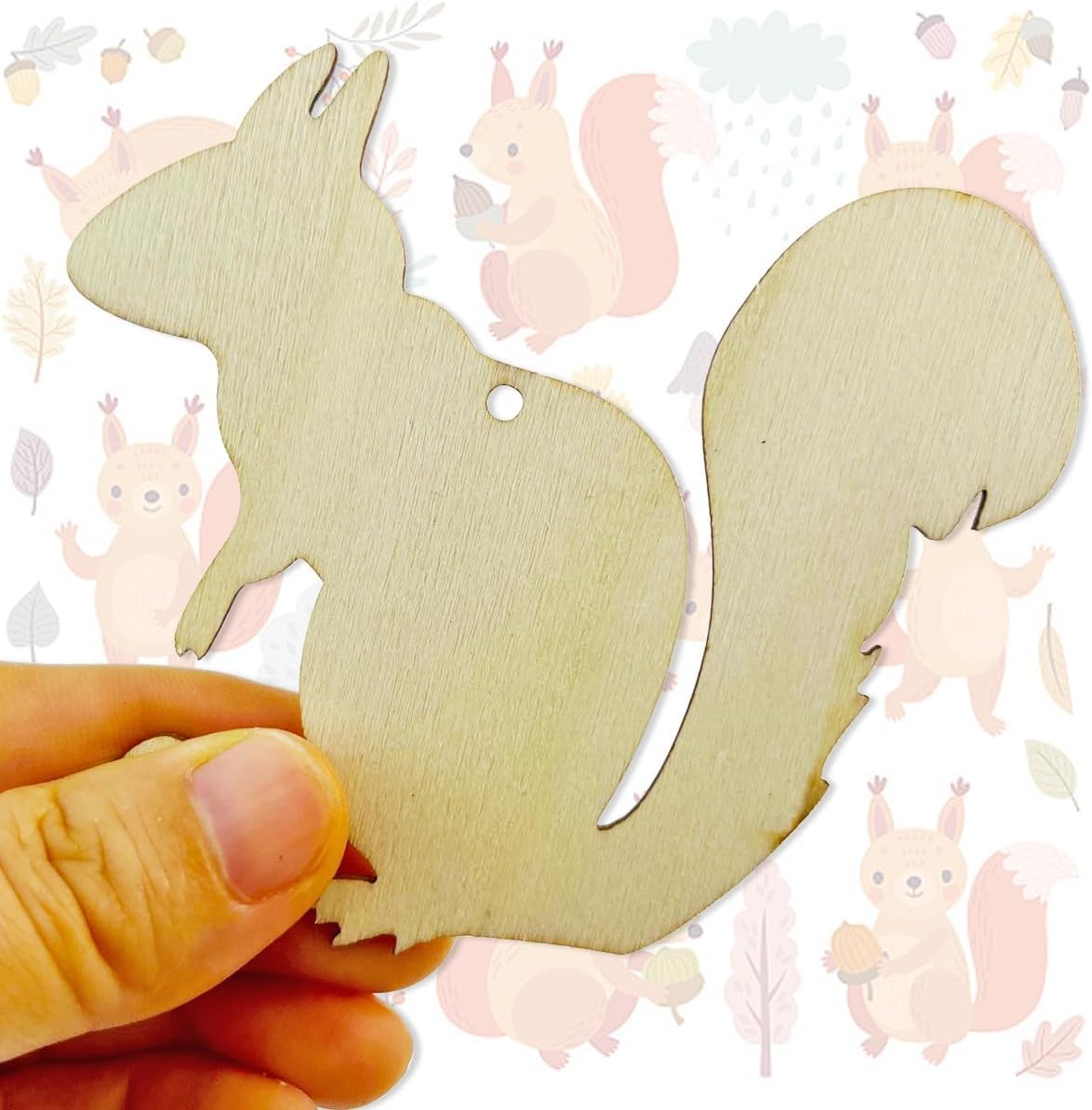 Wooden squirrel-shaped cutout held by a hand with a soft focus background featuring similar shapes.