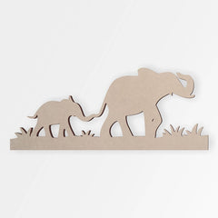 Wooden cutout of two elephants on a white background