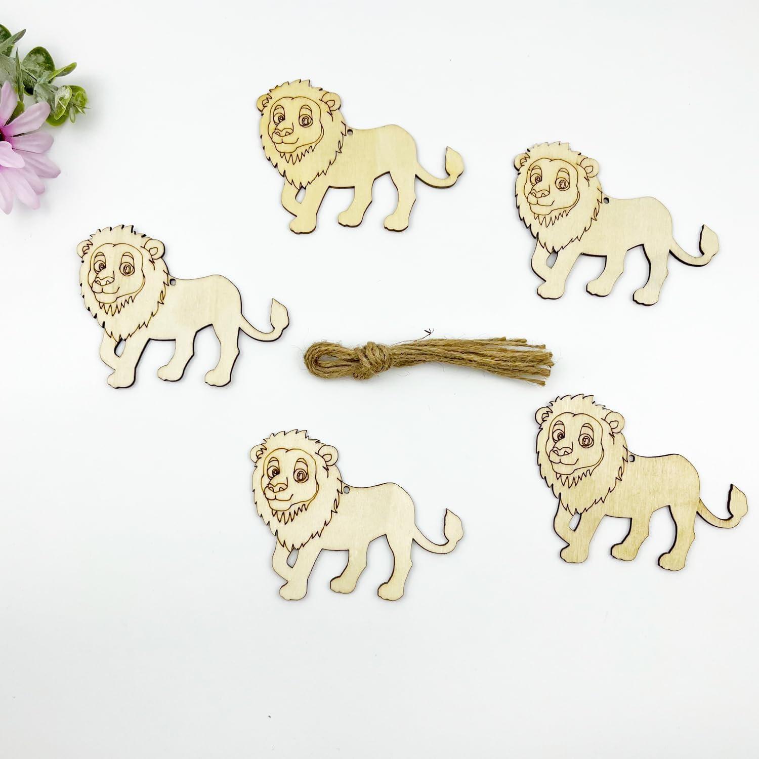 Five wooden lion figurines with a bundle of twine on a white background