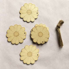 Four wooden flower-shaped tags with a string on a light background
