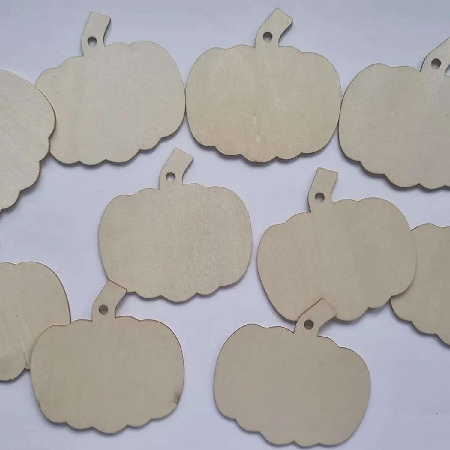 Beige pumpkin-shaped tags on a white background