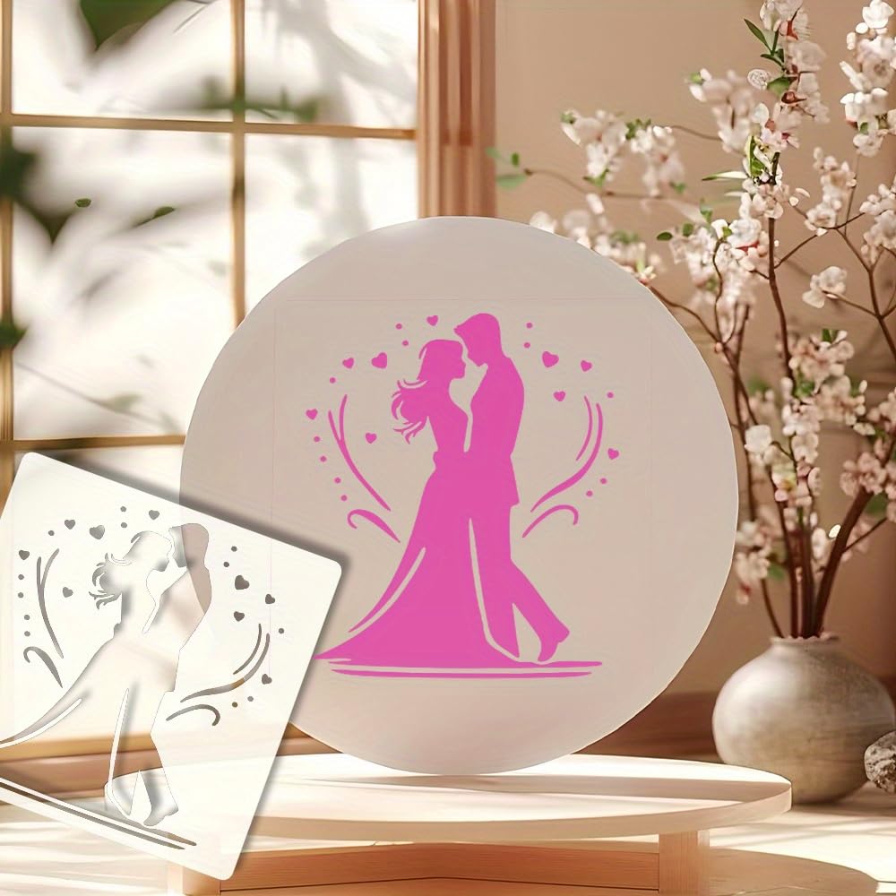 Decorative plate with pink silhouette of a couple and hearts, next to a white card with similar design, on a light wooden surface.