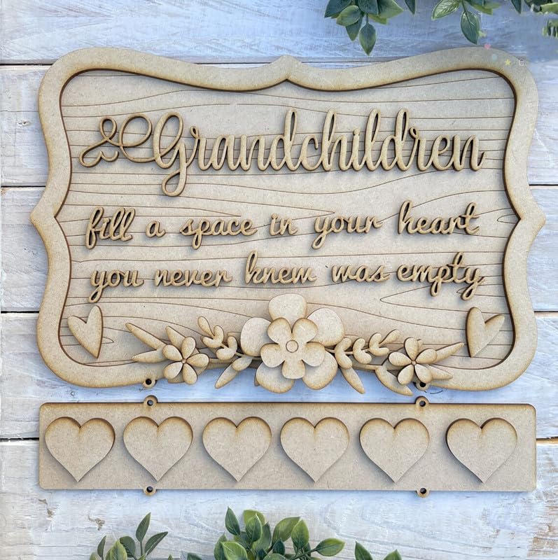 Wooden decorative sign with engraved text and floral designs on a wooden background.