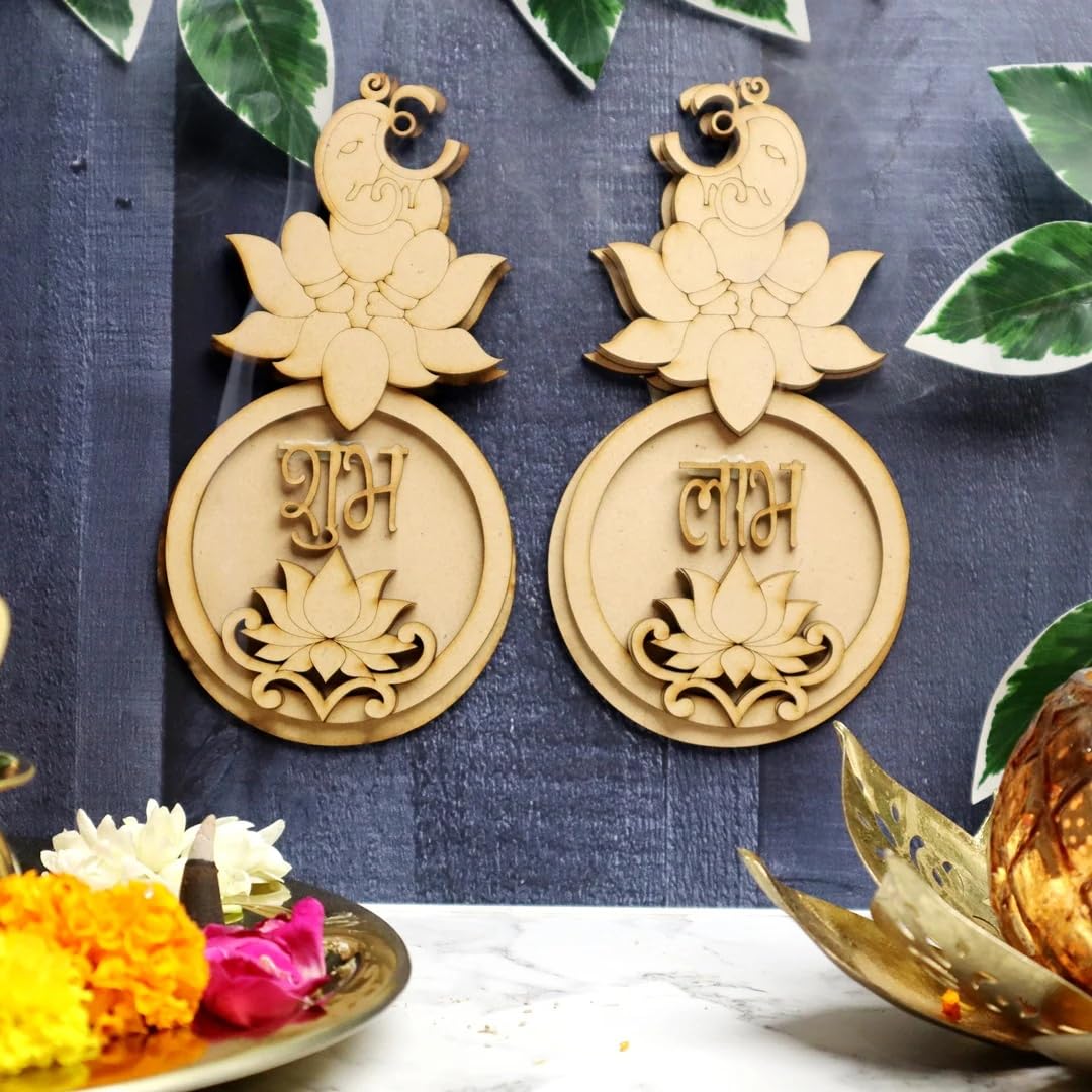 Pair of gold earrings with decorative elements on a blue fabric background.