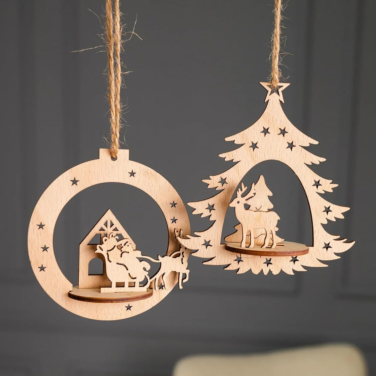 Wooden Christmas tree and house decorations hanging on a dark background