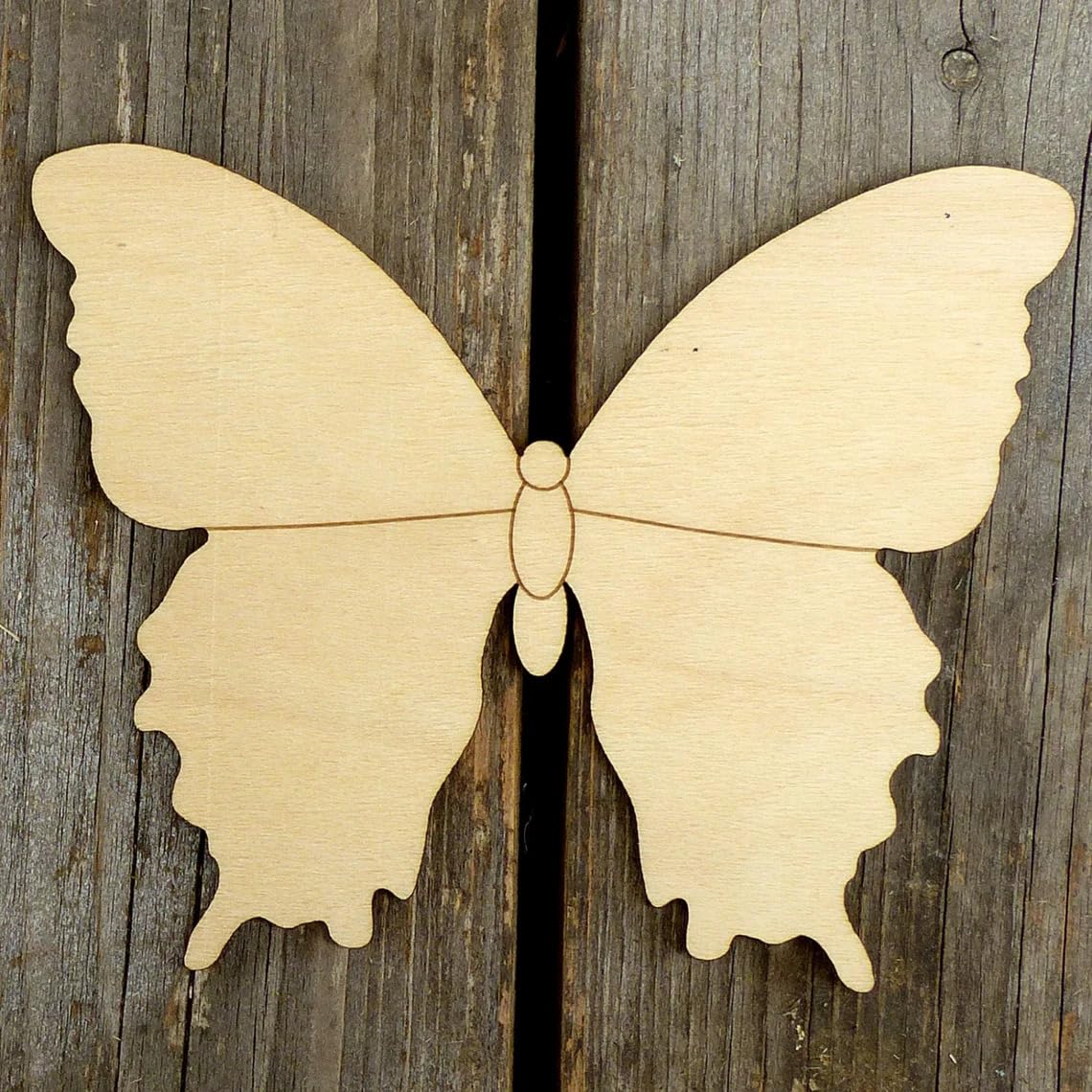 Wooden butterfly cutout on a wooden background