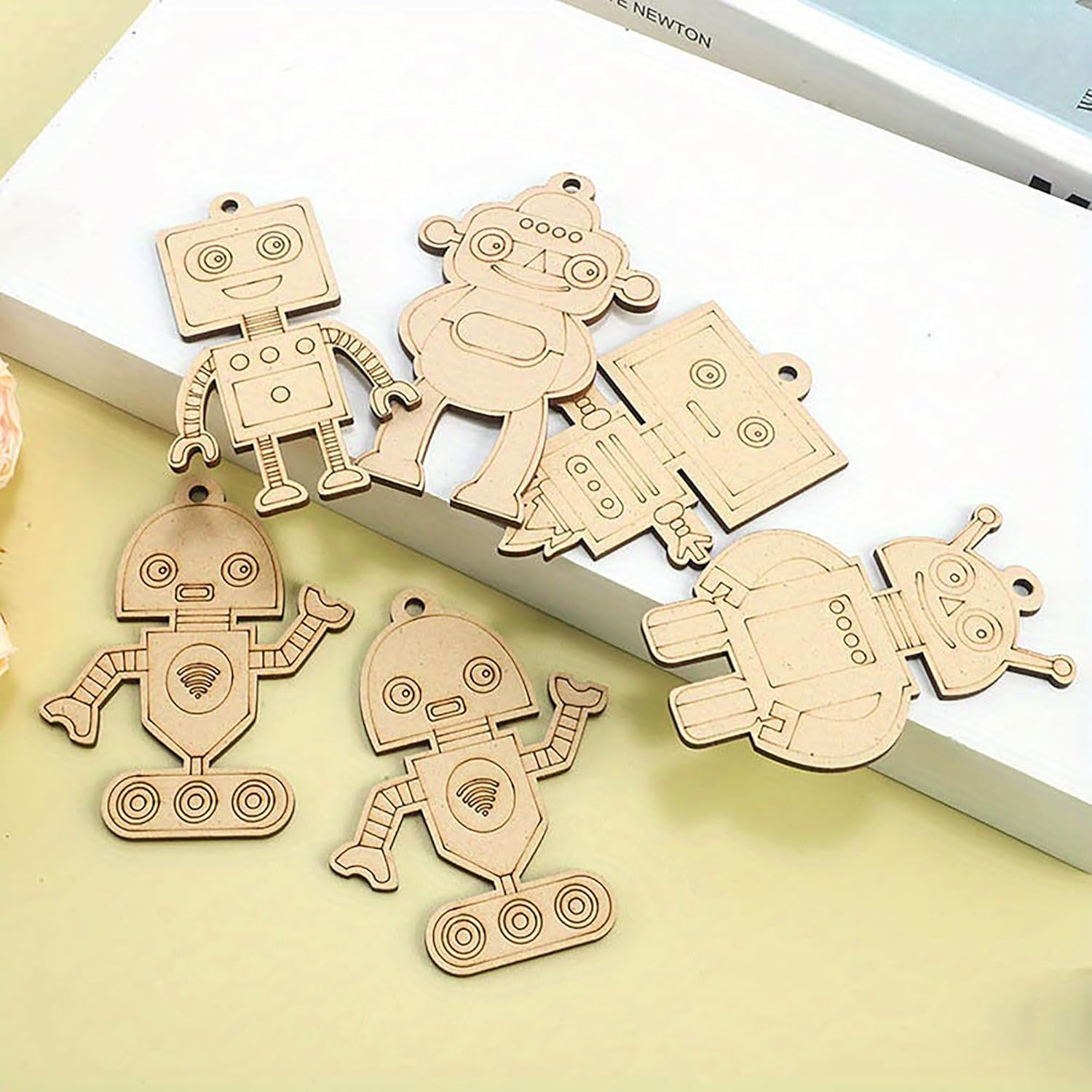 Wooden robot ornaments on a light surface