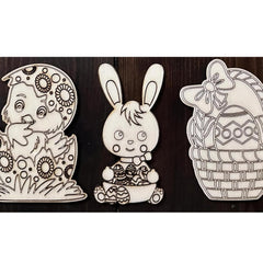 Three Easter-themed cutouts including a bunny, an egg, and a basket on a wooden background.