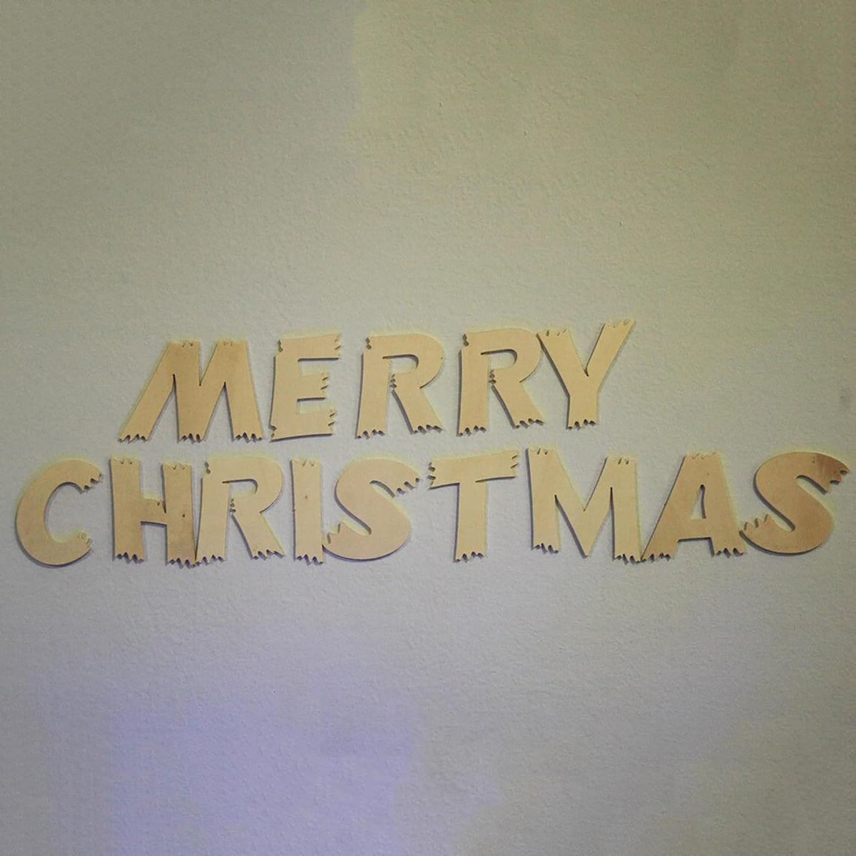 Wooden 'Merry Christmas' letters on a light background
