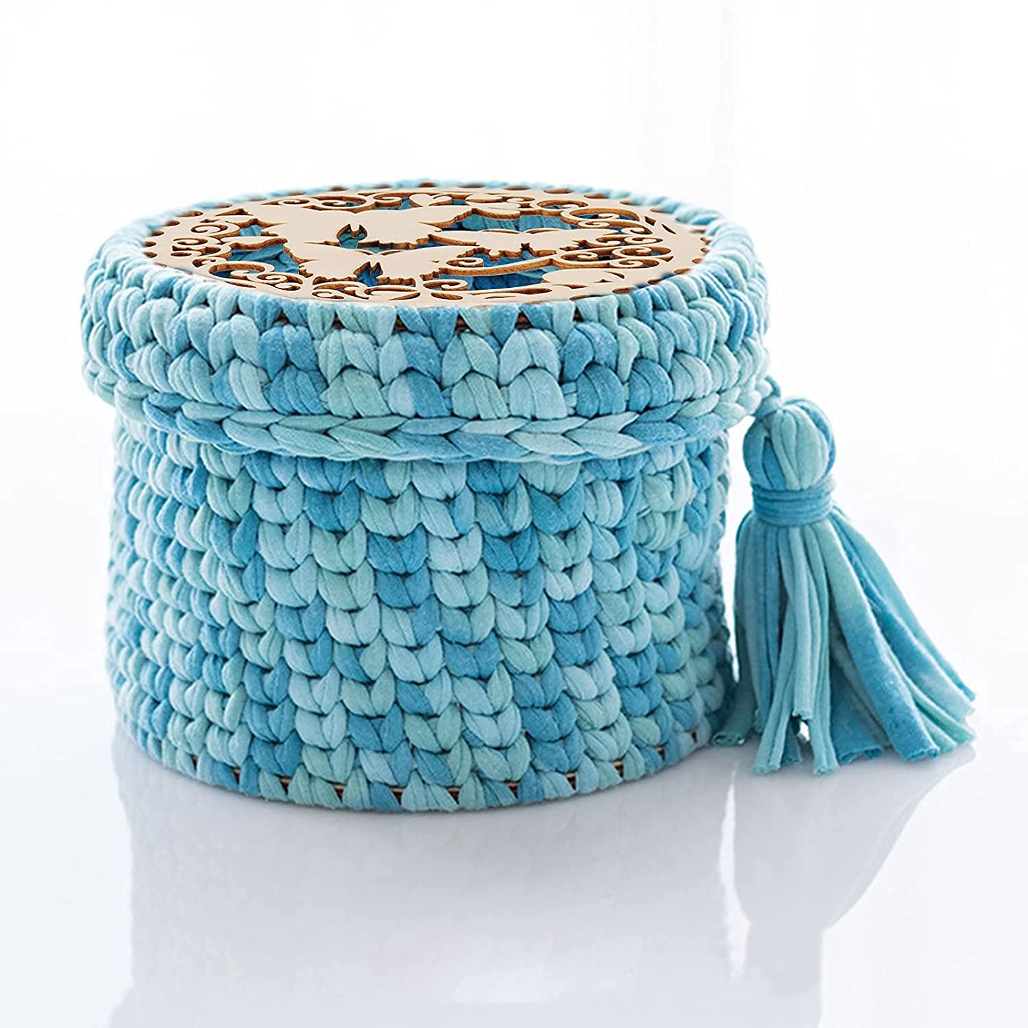 Blue woven basket with a tassel on a white background