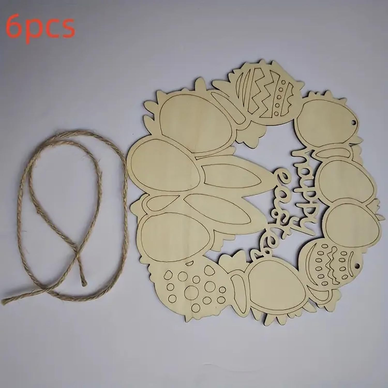 Wooden wreath cutout with decorative elements and twine on a white background