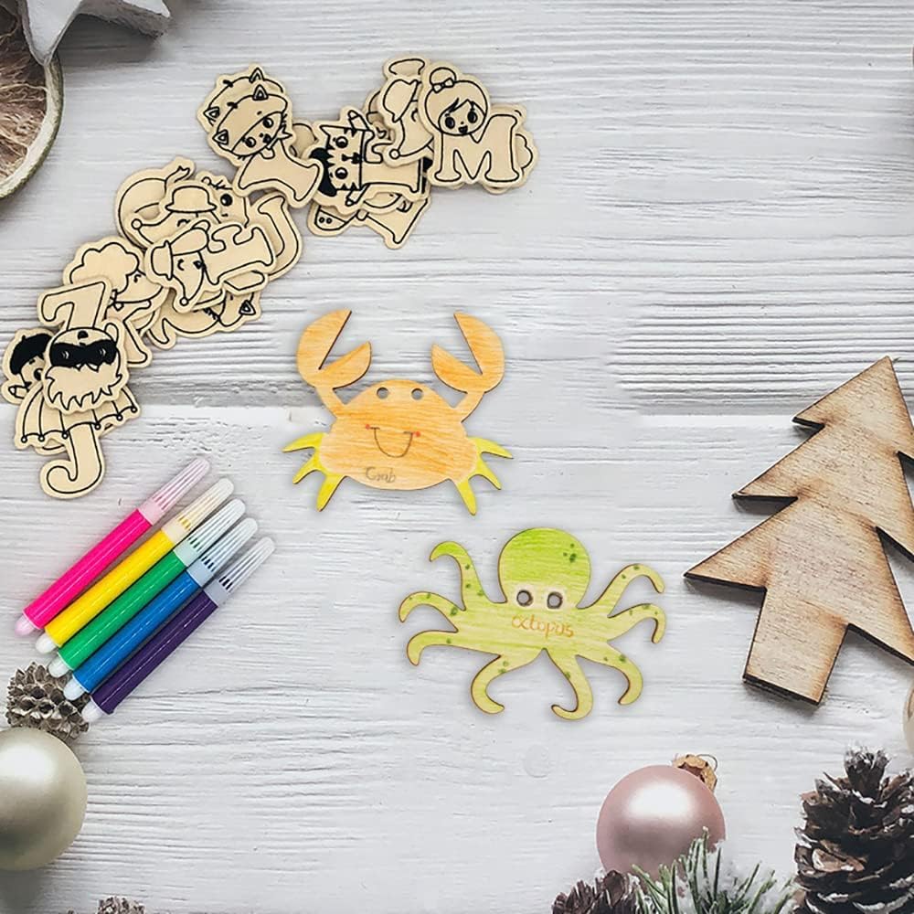 Wooden cutouts of animals and Christmas trees with markers on a light wooden surface.