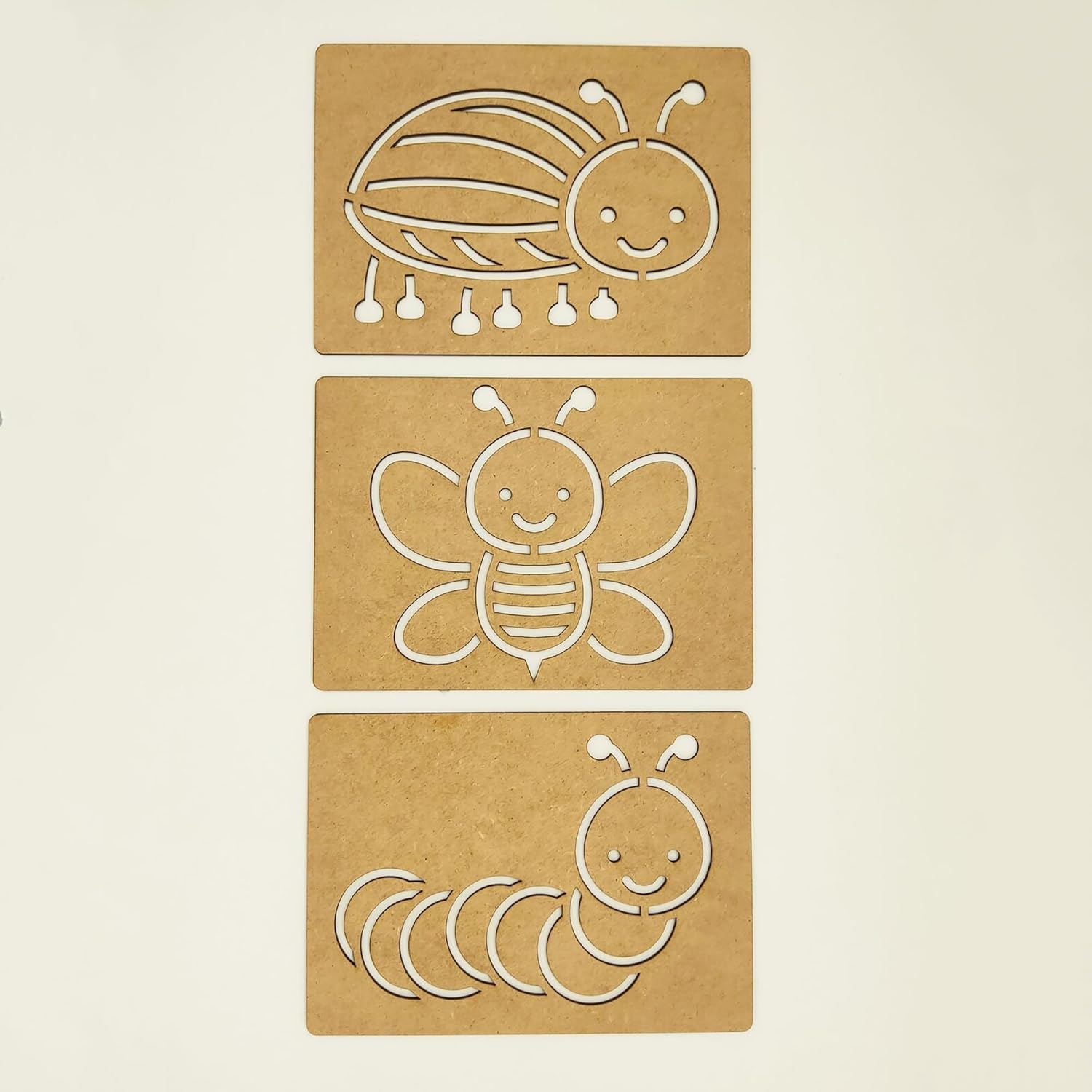 Three cardboard cutouts of cartoon insects on a beige background