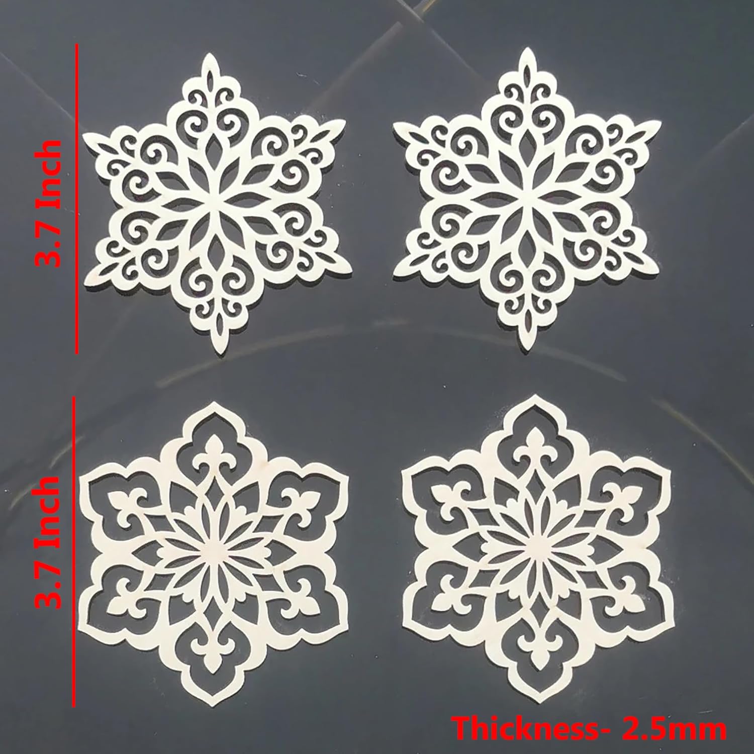 Four white snowflake-shaped cutouts with measurements on a dark background