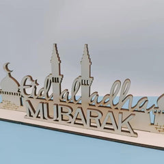 Wooden decorative sign with 'Eid al-Adha Mubarak' text on a light blue background