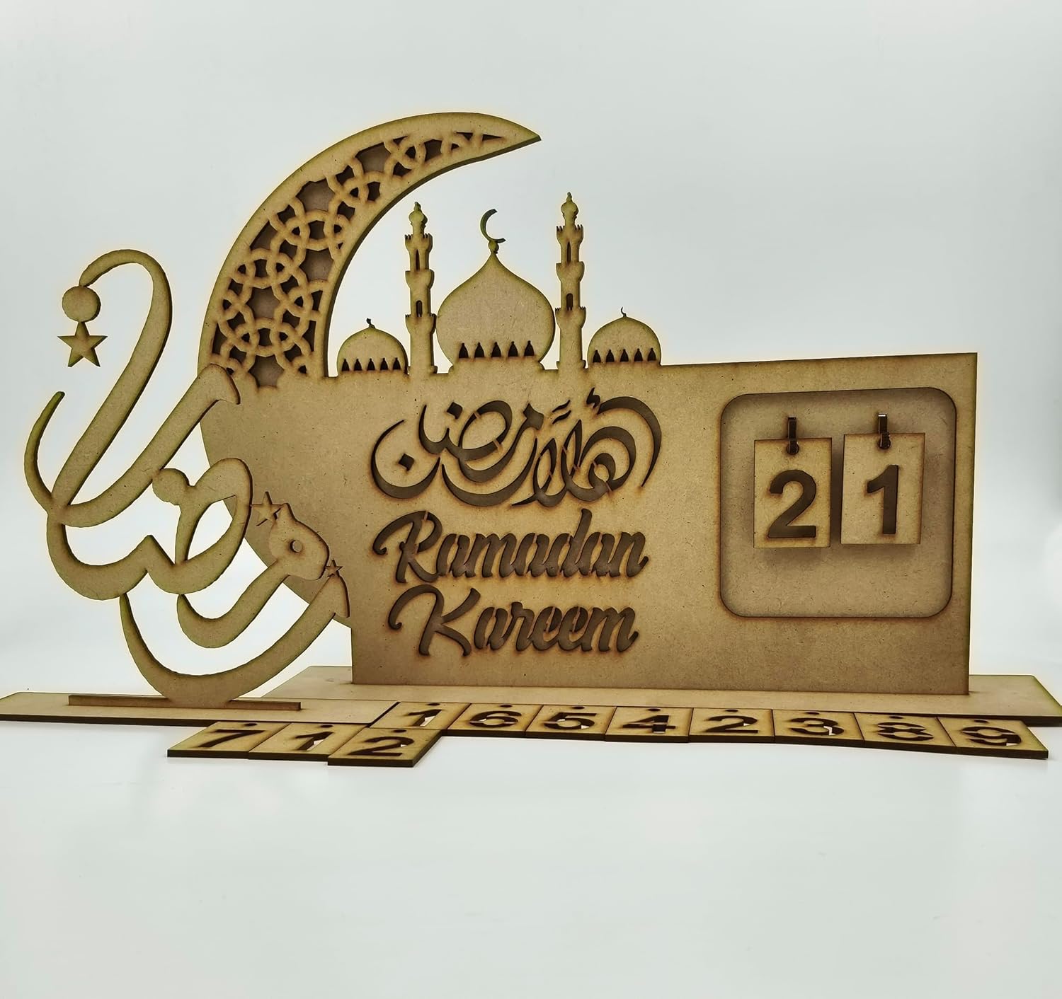 Wooden Ramadan Kareem decorative item with calendar and crescent moon design on a white background