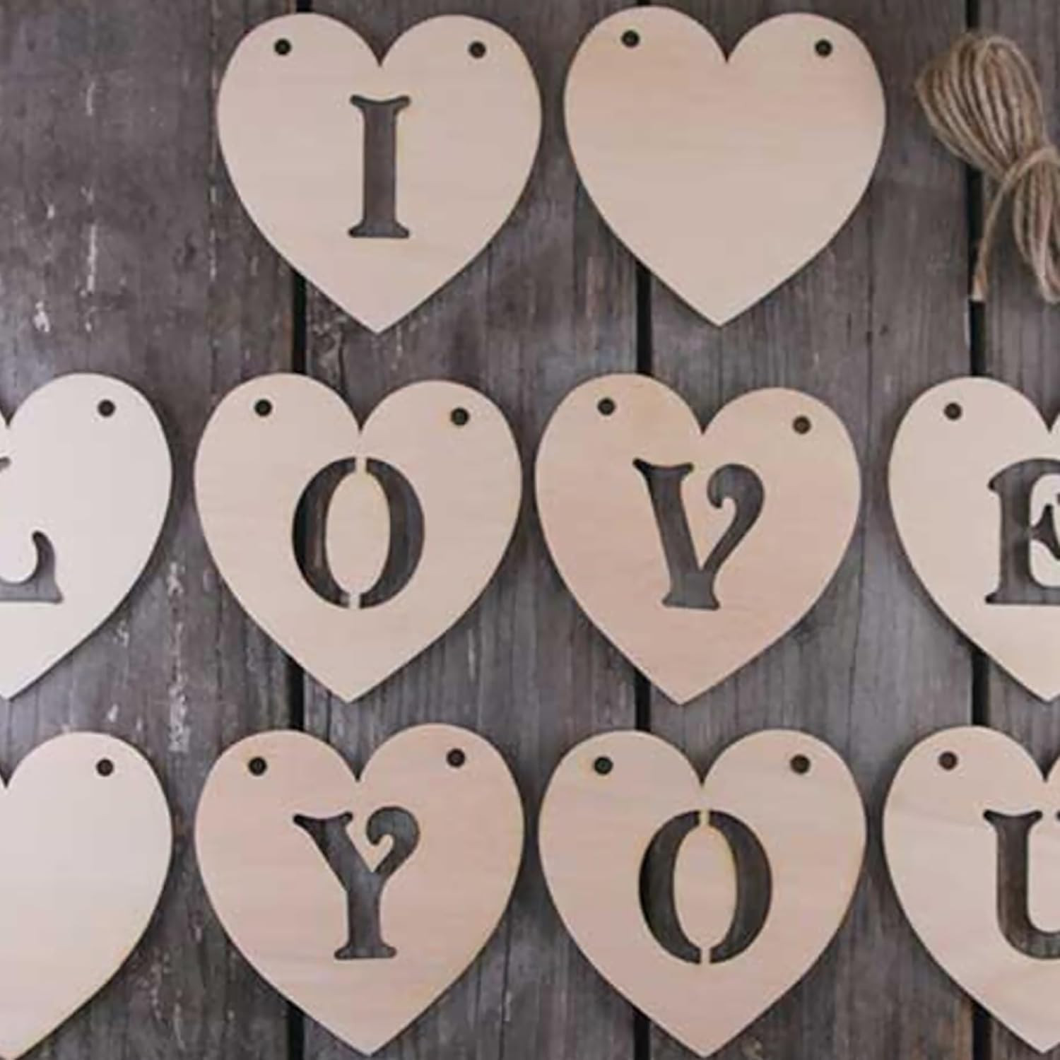 Wooden heart-shaped letters spelling 'I LOVE YOU' on a wooden background